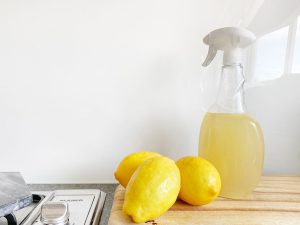 Yellow lemons and spray bottle in a countertop