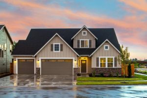 Brown and gray painted house with cemented driveway.